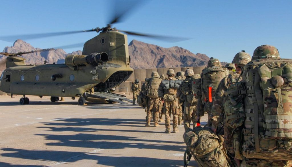 Soldiers attached to the 101st Resolute Support Sustainment Brigade, Iowa National Guard and 10th Mountain, 2-14 Infantry Battalion, load onto a Chinook helicopter to head out on a mission in Afghanistan