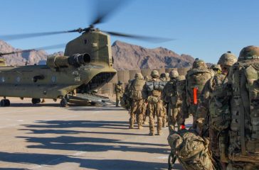Soldiers attached to the 101st Resolute Support Sustainment Brigade, Iowa National Guard and 10th Mountain, 2-14 Infantry Battalion, load onto a Chinook helicopter to head out on a mission in Afghanistan